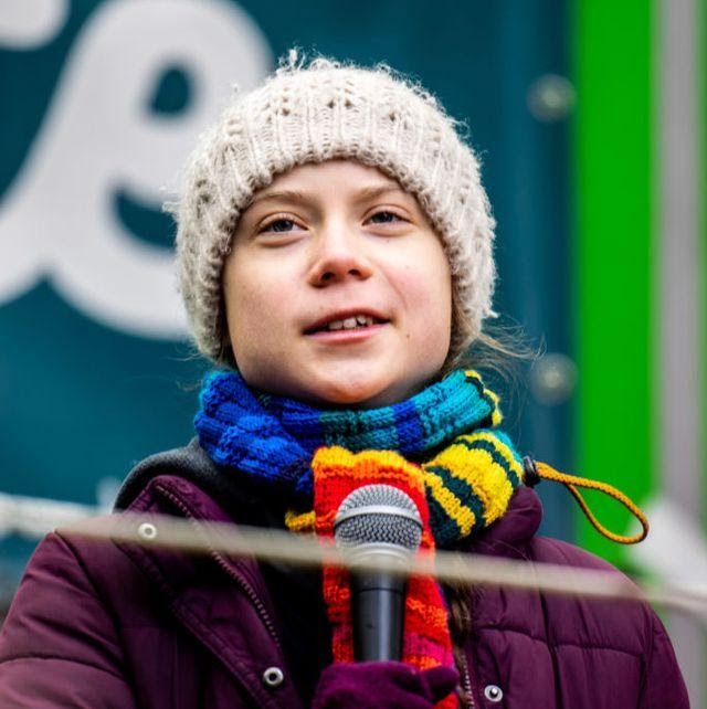 Greta Thunberg speaking into a microphone.